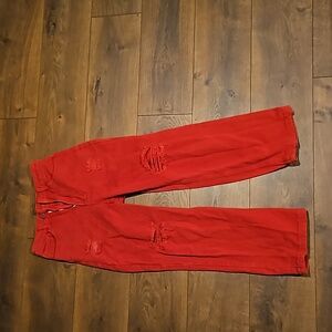 Red jeans with rips holes wide leg cut